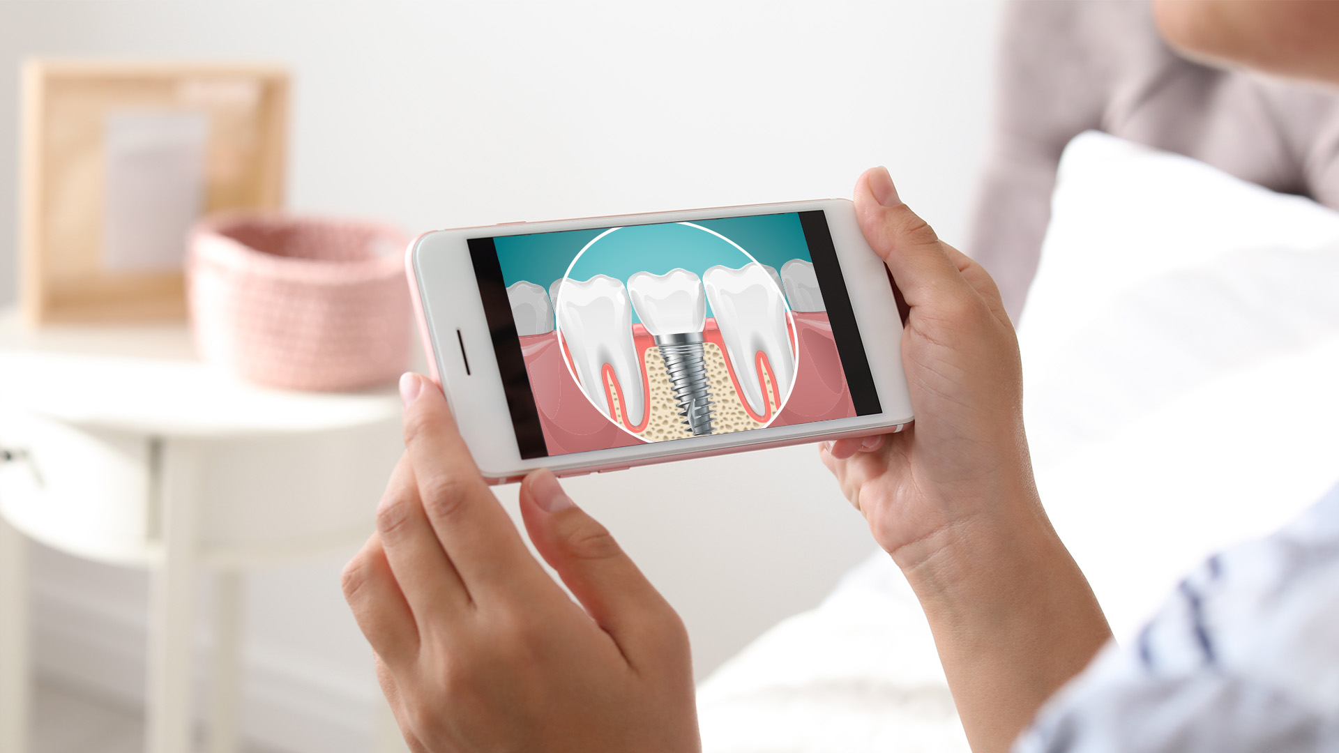 The image shows a person holding a smartphone displaying an image of a tooth with a visible cavity on the screen, while another person s face is partially visible in the background.