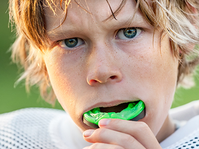 A split-screen image featuring two different moments of a young boy with blonde hair; on the left, he's holding his mouth open wide, and on the right, he's chewing on something green.